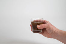 Load image into Gallery viewer, man holding a cup of essiac